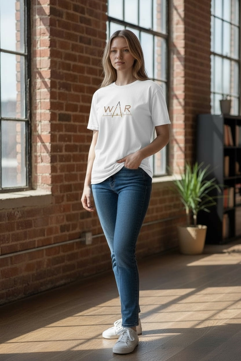 Woman wearing a white t-shirt with 'WAR APPAREL' logo in a sunlit room with brick walls.